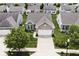Charming home featuring a two-car garage, and well-maintained front yard with mature trees and landscaping at 15937 Marsala Dr, Fishers, IN 46037