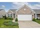 Inviting home exterior with a two-car garage, brick accents, and a neatly landscaped front yard at 15937 Marsala Dr, Fishers, IN 46037