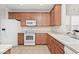 Functional kitchen features tiled floors, neutral countertops, and wood cabinetry at 15937 Marsala Dr, Fishers, IN 46037