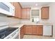 Bright kitchen with tiled floor and a view out to the dining area through the window at 15937 Marsala Dr, Fishers, IN 46037