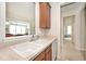 Kitchen with white basin sink looks through serving hatch to the dining area at 15937 Marsala Dr, Fishers, IN 46037