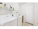 Bright laundry room with washer, dryer, sink, and access to the outside at 15937 Marsala Dr, Fishers, IN 46037