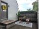 Charming back patio with outdoor furniture and a decorative welcome mat at 1637 Meridian St, Columbus, IN 47201