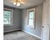 This cozy bedroom features neutral carpet, two windows, and a ceiling fan at 1637 Meridian St, Columbus, IN 47201