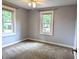 Bright bedroom with gray walls, neutral carpeting, and plenty of natural light from two windows at 1637 Meridian St, Columbus, IN 47201