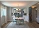 Dining room flows into kitchen, featuring wood floors, modern light fixtures and gray paint at 1637 Meridian St, Columbus, IN 47201