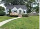 Charming home with a well-manicured lawn, inviting front porch and beautiful landscaping at 1637 Meridian St, Columbus, IN 47201