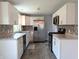 Modern kitchen with white cabinets, stainless steel appliances and updated backsplash at 1637 Meridian St, Columbus, IN 47201