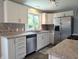 Modern kitchen with white cabinets, stainless steel appliances and granite countertops at 1637 Meridian St, Columbus, IN 47201