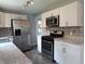 Bright kitchen with stainless steel appliances, granite countertops and modern cabinets at 1637 Meridian St, Columbus, IN 47201