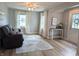 Inviting living room with neutral paint, wood floors, updated decor, and lots of natural light at 1637 Meridian St, Columbus, IN 47201