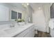 Bright bathroom with a double sink vanity, framed mirror, and tub with neutral tile at 16465 Mount Logan Rd, Noblesville, IN 46060