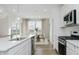 Bright, open kitchen featuring stainless steel appliances, quartz countertops, and a view to the dining area at 16465 Mount Logan Rd, Noblesville, IN 46060