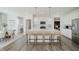Modern kitchen with large island, seating, stainless appliances, and light wood flooring at 16465 Mount Logan Rd, Noblesville, IN 46060