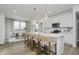 A well-lit kitchen features modern appliances, a quartz island with bar stool seating, and an adjacent dining area at 16465 Mount Logan Rd, Noblesville, IN 46060