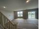 Bright open living space featuring large windows and patio door at 16465 Mount Logan Rd, Noblesville, IN 46060