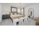 A serene main bedroom featuring soft lighting, a decorative chandelier, and a comfortable bed and side tables at 16465 Mount Logan Rd, Noblesville, IN 46060