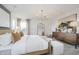 A bright main bedroom featuring soft lighting, a decorative chandelier, and a comfortable bed and side tables at 16465 Mount Logan Rd, Noblesville, IN 46060