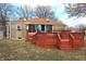 Backyard view showcasing a charming home with a spacious deck, perfect for outdoor gatherings at 1739 Forest Dr, Indianapolis, IN 46227