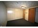 A finished basement with wood paneled walls, neutral carpet, and a decorative textured ceiling at 1739 Forest Dr, Indianapolis, IN 46227
