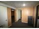 Open basement area with a mini-fridge and textured ceiling at 1739 Forest Dr, Indianapolis, IN 46227