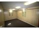 Finished basement with wood-paneled walls, carpeted floors, and natural light from the windows at 1739 Forest Dr, Indianapolis, IN 46227