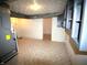 Unfinished basement area with mechanicals, open doorway, and painted concrete walls at 1739 Forest Dr, Indianapolis, IN 46227