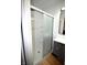 Bright bathroom featuring a modern shower with sliding glass doors and a sleek vanity at 1739 Forest Dr, Indianapolis, IN 46227