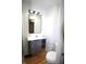 Modern bathroom with updated vanity, stylish lighting, and a convenient toilet and shower setup at 1739 Forest Dr, Indianapolis, IN 46227