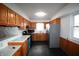Large bedroom featuring hardwood floors, a window, and ensuite bathroom access at 1739 Forest Dr, Indianapolis, IN 46227