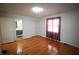 Large bedroom featuring hardwood floors, a window, and ensuite bathroom access at 1739 Forest Dr, Indianapolis, IN 46227