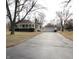 Charming single-story home with a detached garage and long driveway nestled amongst mature trees at 1739 Forest Dr, Indianapolis, IN 46227