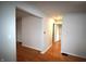 A bright hallway with light paint and beautiful hardwood floors leads to multiple rooms at 1739 Forest Dr, Indianapolis, IN 46227
