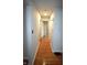 A bright hallway with light paint and beautiful hardwood floors leads to multiple rooms at 1739 Forest Dr, Indianapolis, IN 46227