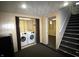 Laundry area in the basement with a folding door and nearby stairs at 1739 Forest Dr, Indianapolis, IN 46227