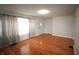 Spacious living room with gleaming hardwood floors and large window that flood the room with natural light at 1739 Forest Dr, Indianapolis, IN 46227