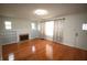 Bright living room featuring hardwood floors, built-in bookcases, and a decorative fireplace at 1739 Forest Dr, Indianapolis, IN 46227