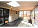 Bright sunroom featuring stone accent wall, skylight, and sliding glass doors to backyard deck at 1739 Forest Dr, Indianapolis, IN 46227