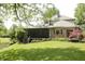 Backyard view featuring lush lawn, pond, and screened-in porch at 1739 S County Road 450 E, Avon, IN 46123