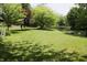 Expansive backyard featuring a serene pond with lush green trees and grass at 1739 S County Road 450 E, Avon, IN 46123