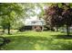 Green backyard featuring a pond, lush lawn, and a view of the home at 1739 S County Road 450 E, Avon, IN 46123