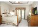 Warm bedroom with four-poster bed, dresser, and sliding glass doors to the exterior at 1739 S County Road 450 E, Avon, IN 46123