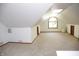 Spacious bonus room with carpet, window, skylight, and clean, white walls at 1739 S County Road 450 E, Avon, IN 46123