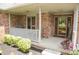 Covered front porch featuring brick columns and trim with flower boxes and plants at 1739 S County Road 450 E, Avon, IN 46123