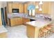 Traditional kitchen featuring wood cabinets, a breakfast bar with seating and modern appliances at 1739 S County Road 450 E, Avon, IN 46123