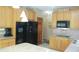 Updated kitchen showcasing wooden cabinets, black appliances, and ample counter space at 1739 S County Road 450 E, Avon, IN 46123