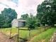 Fenced backyard with mature trees and a well-kept lawn, offering privacy and a natural setting at 196 Bakemeyer St, Indianapolis, IN 46225