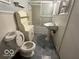Small bathroom with a toilet, sink, shelving and a shower/bath combo at 196 Bakemeyer St, Indianapolis, IN 46225