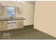 Small kitchen with tile floors, a window and cabinetry at 196 Bakemeyer St, Indianapolis, IN 46225