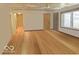 Bright living room with hardwood floors, ceiling fan, and natural light from the large window at 196 Bakemeyer St, Indianapolis, IN 46225